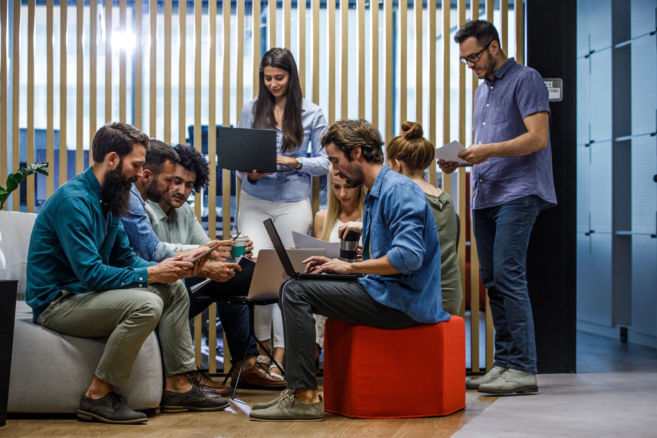 Group of diligent business people co-working in the office lounge area